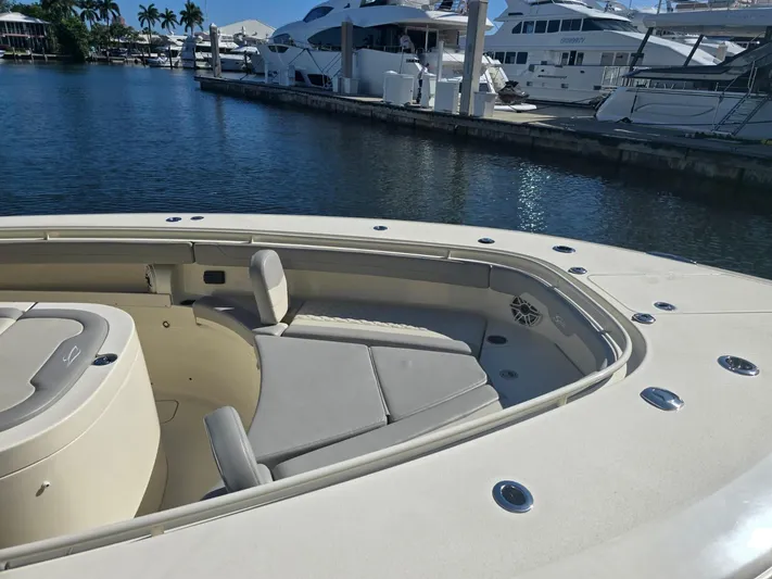 Yacht Photos Pics 2024 Scout 355 LXF boat interior with seating, docked at marina.
