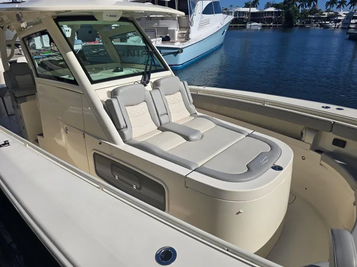  Yacht Photos Pics 2024 Scout 355 LXF luxury boat with sleek design, docked in marina.