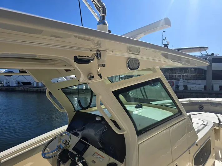  Yacht Photos Pics 2024 Scout 355 LXF boat helm with modern controls and sleek design, docked by the water.