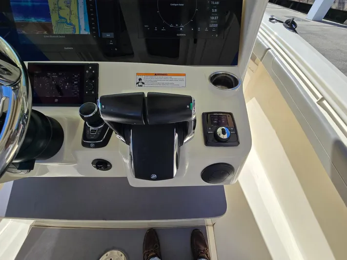  Yacht Photos Pics 2024 Scout 355 LXF boat dashboard with navigation controls and display screens.