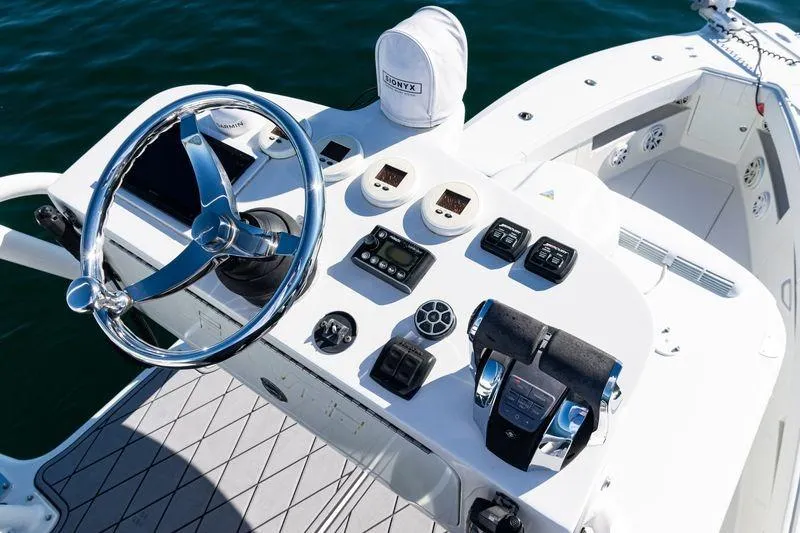  Yacht Photos Pics 2016 SeaVee 390Z boat helm with steering wheel and control panel on open water.