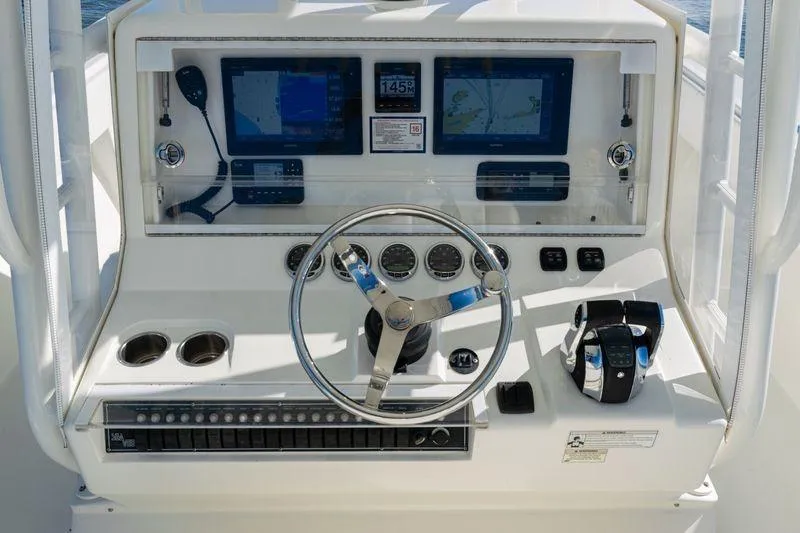  Yacht Photos Pics 2016 SeaVee 390Z boat dashboard with steering wheel, controls, and navigation screens.