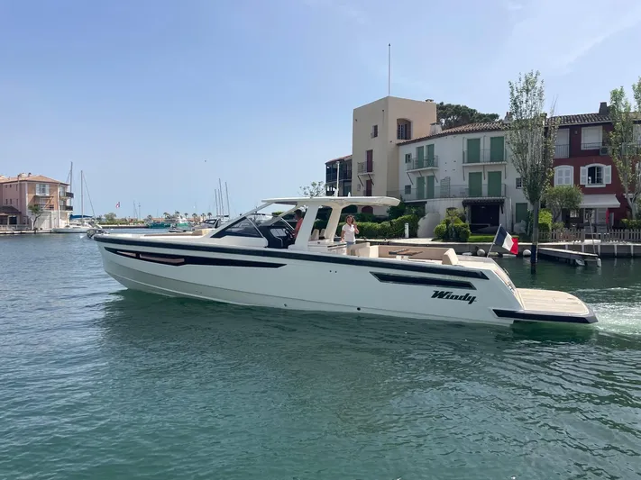  Yacht Photos Pics 2022 Windy SR 44 BLACKHAWK yacht cruising in a scenic harbor setting.