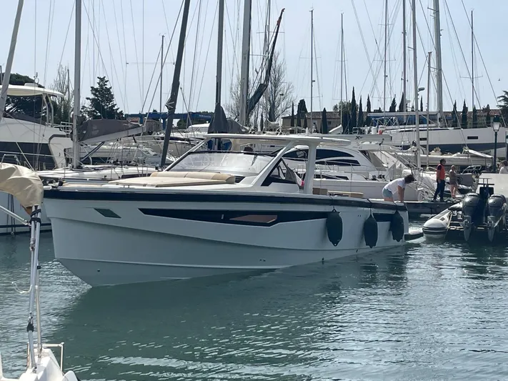  Yacht Photos Pics 2022 Windy SR 44 BLACKHAWK yacht docked in a marina, surrounded by other boats.