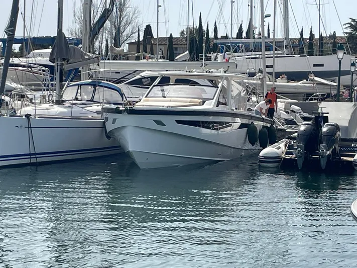  Yacht Photos Pics 2022 Windy SR 44 BLACKHAWK yacht docked in a marina, surrounded by other boats.