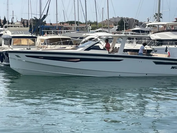  Yacht Photos Pics 2022 Windy SR 44 BLACKHAWK yacht docked in a marina, surrounded by other boats.