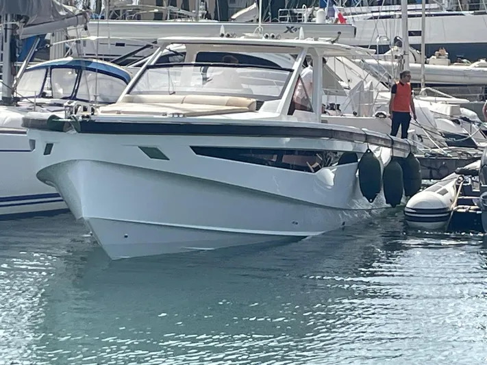  Yacht Photos Pics 2022 Windy SR 44 BLACKHAWK yacht docked in a marina, with a person standing nearby.