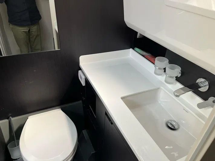  Yacht Photos Pics Modern bathroom in 2022 Windy SR 44 BLACKHAWK yacht with sleek sink and toilet.