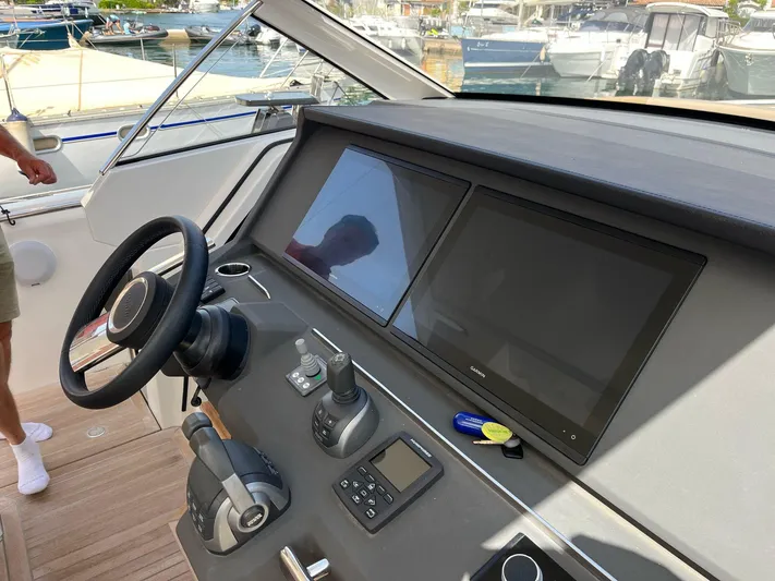  Yacht Photos Pics 2022 Windy SR 44 BLACKHAWK yacht dashboard with steering wheel and navigation screens.