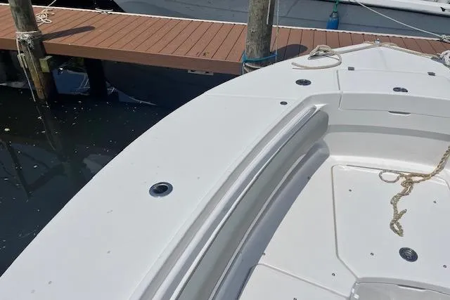  Yacht Photos Pics 2024 Regulator 28 boat docked, showcasing sleek white deck design.