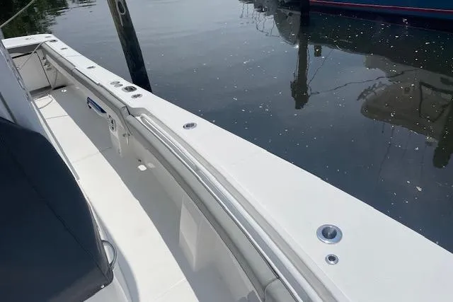  Yacht Photos Pics 2024 Regulator 28 boat interior with sleek white deck by the water.