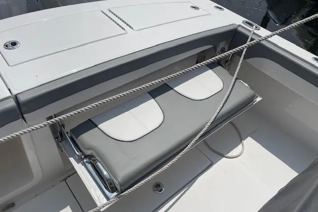  Yacht Photos Pics 2024 Regulator 28 boat with cushioned seating and sleek design.