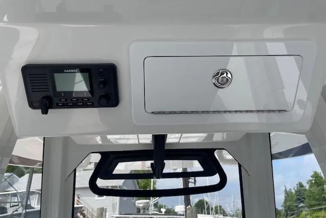  Yacht Photos Pics 2024 Regulator 28 boat interior with Garmin device and storage compartment.