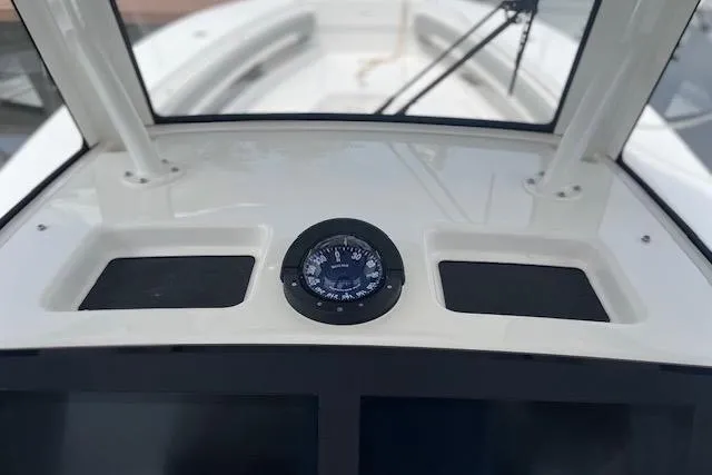  Yacht Photos Pics 2024 Regulator 28 boat dashboard with compass and storage compartments.