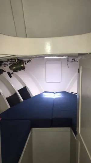 Constellation Yacht Photos Pics Interior cabin of a 1984 Sunny Briggs Custom Carolina boat with blue bedding.