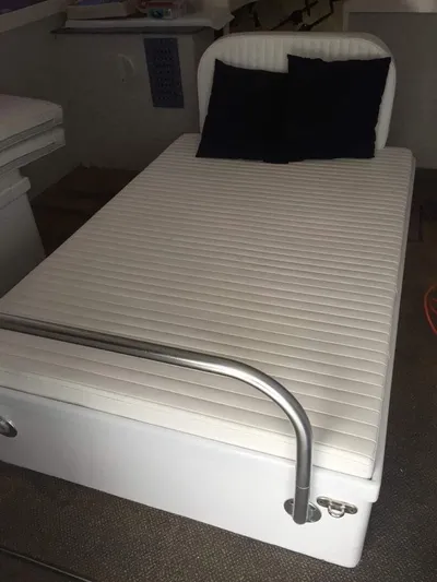 Constellation Yacht Photos Pics White bed in 1984 Sunny Briggs Custom Carolina boat cabin with black pillows.