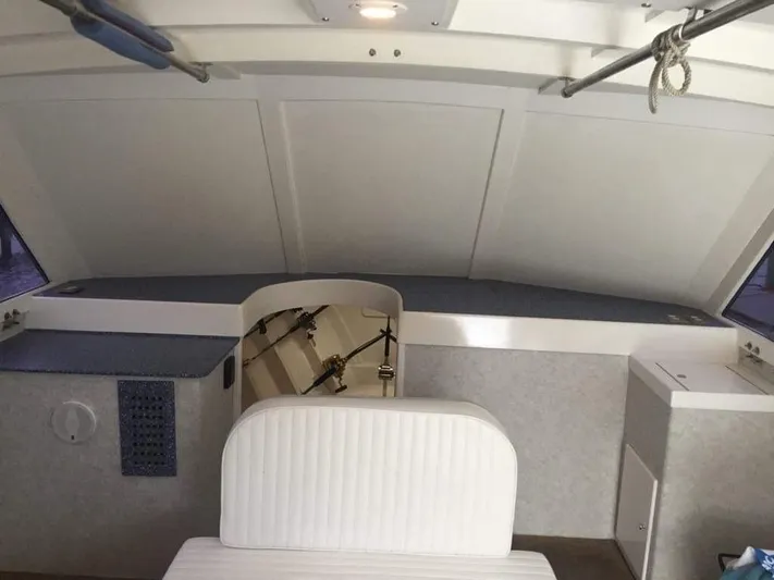 Constellation Yacht Photos Pics Interior of 1984 Sunny Briggs Custom Carolina boat with white seating and storage compartments.