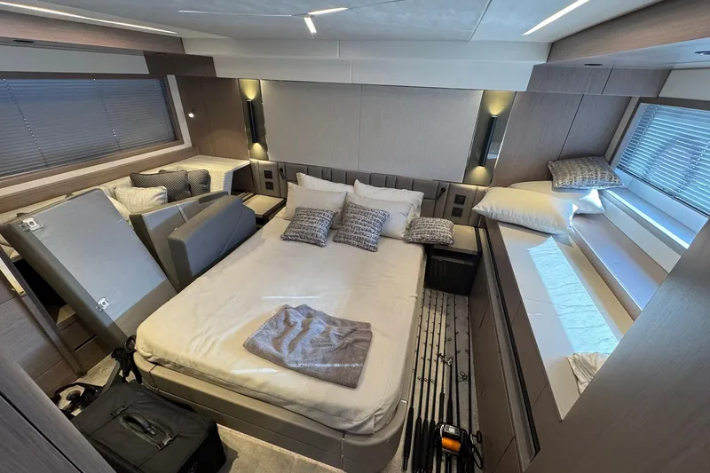  Yacht Photos Pics Luxurious bedroom interior of 2022 Sunseeker Manhattan 55 yacht, featuring modern design and cozy bedding.