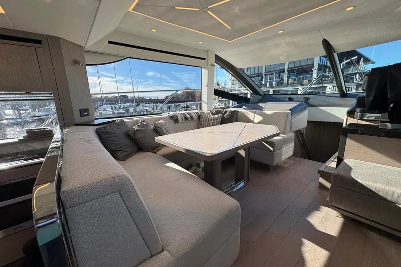  Yacht Photos Pics Luxurious interior of 2022 Sunseeker Manhattan 55 yacht with elegant seating and panoramic windows.