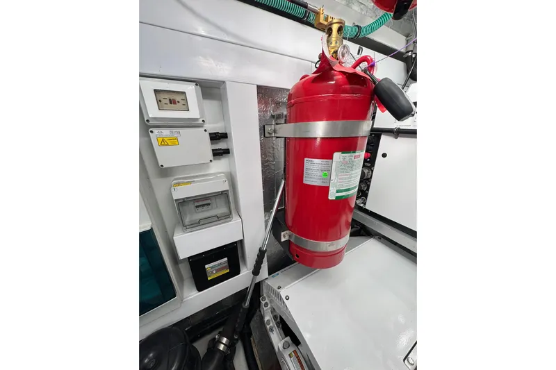  Yacht Photos Pics Engine room of 2022 Sunseeker Manhattan 55 with fire extinguisher and control panels.