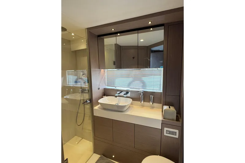  Yacht Photos Pics Luxurious bathroom in 2022 Sunseeker Manhattan 55 yacht with modern fixtures and elegant design.