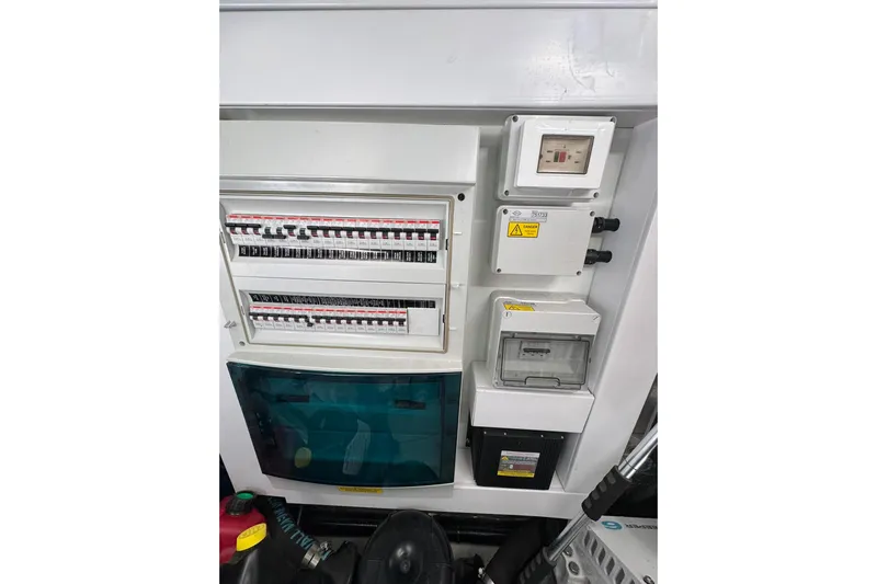  Yacht Photos Pics Electrical panel on a 2022 Sunseeker Manhattan 55 yacht, featuring circuit breakers and control boxes.