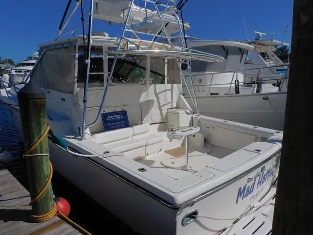 Mad Hatter Yacht Photos Pics 1997 Tiara Yachts Open boat docked at marina, rear view.
