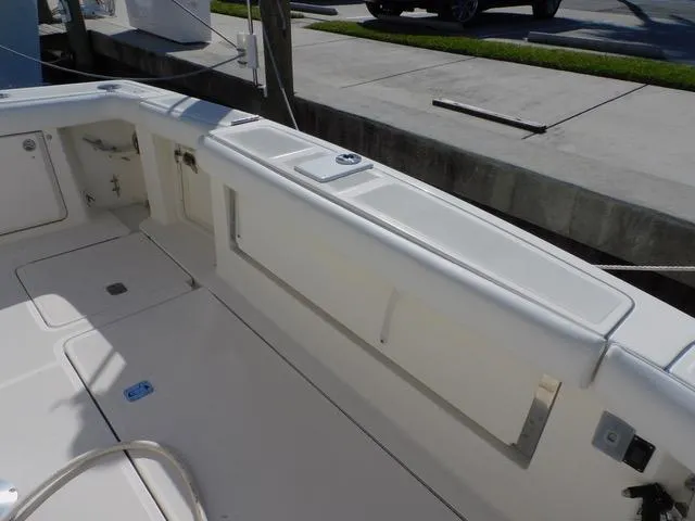Mad Hatter Yacht Photos Pics 1997 Tiara Yachts Open boat deck, featuring clean white surfaces and storage compartments.