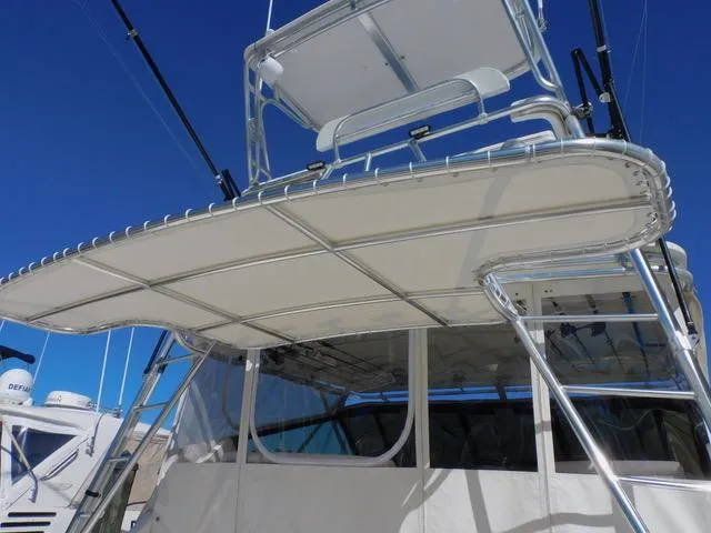 Mad Hatter Yacht Photos Pics 1997 Tiara Yachts Open model with a sturdy canopy and clear blue sky background.