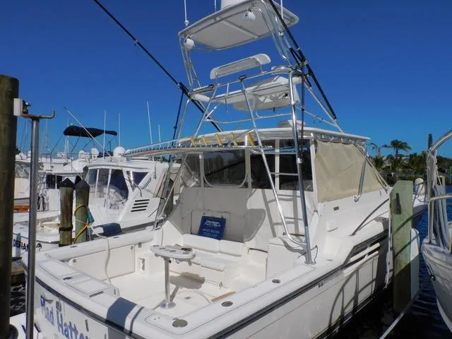 Mad Hatter Yacht Photos Pics 1997 Tiara Yachts Open model docked at marina under clear blue sky.