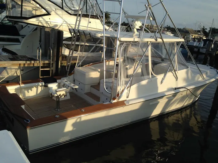 R & R Yacht Photos Pics 2000 Stolper 3800 Tournament Express boat docked at marina, featuring fishing equipment.