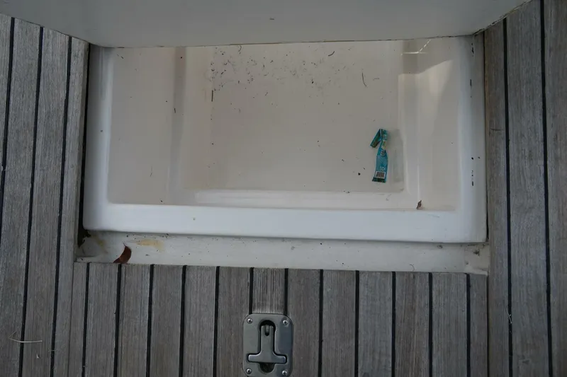 R & R Yacht Photos Pics Stolper 3800 Tournament Express 2000 boat storage compartment with wooden deck.