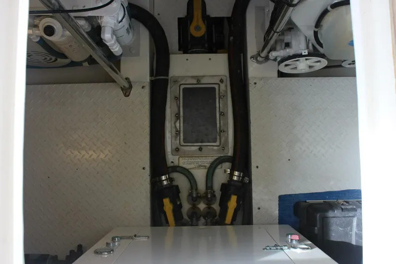 R & R Yacht Photos Pics Engine compartment of a 2000 Stolper 3800 Tournament Express boat, showing hoses and mechanical components.