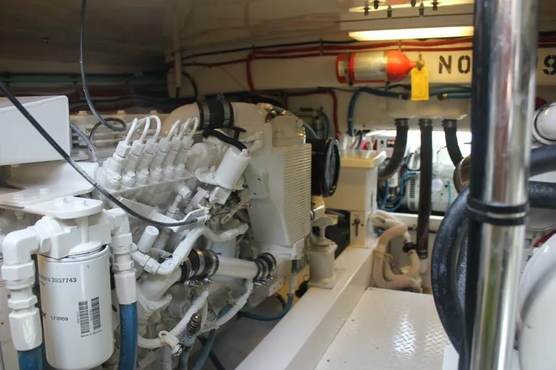 R & R Yacht Photos Pics Engine room of 2000 Stolper 3800 Tournament Express boat, showcasing mechanical components and piping.