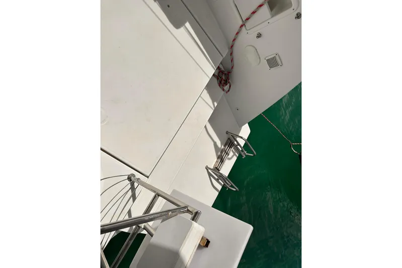  Yacht Photos Pics Deck view of a 2016 Lagoon 42 catamaran with stainless steel fittings and green water.