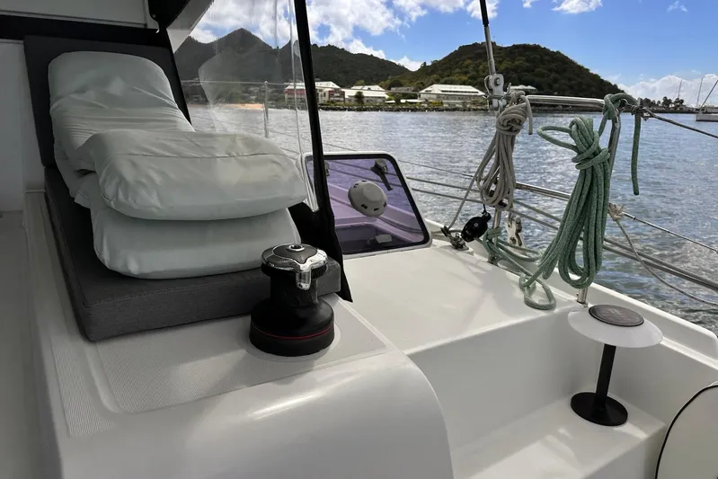  Yacht Photos Pics Lagoon 42 catamaran deck with cushions, ropes, and scenic coastal view, 2016 model.