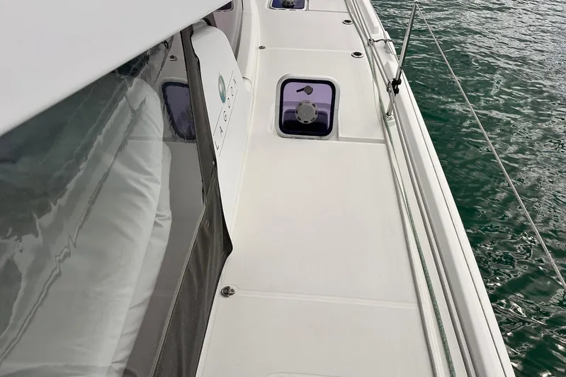  Yacht Photos Pics Deck view of a 2016 Lagoon 42 catamaran, featuring sleek design and ocean backdrop.