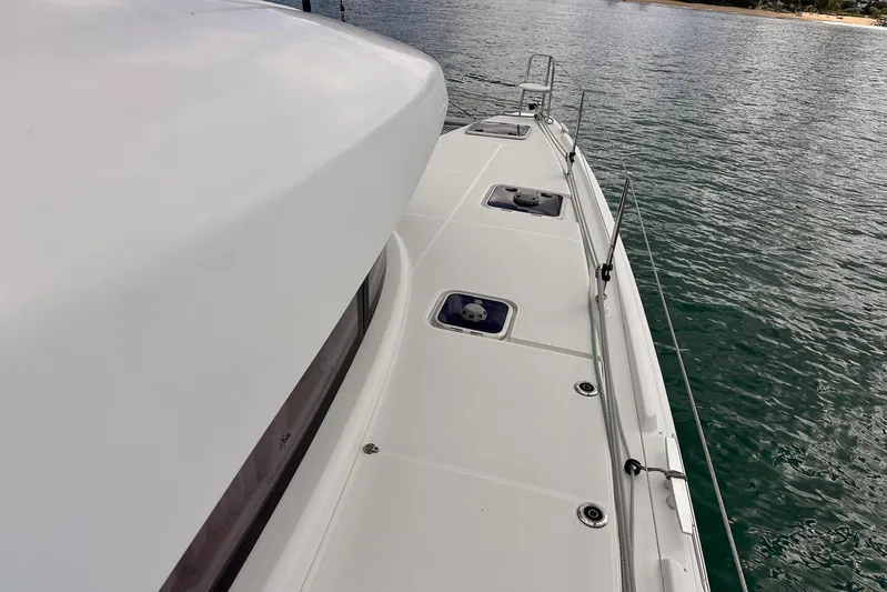  Yacht Photos Pics Deck view of 2016 Lagoon 42 catamaran on calm water.