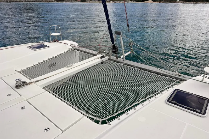 Yacht Photos Pics 2016 Lagoon 42 catamaran with netting over water, showcasing deck and ocean view.
