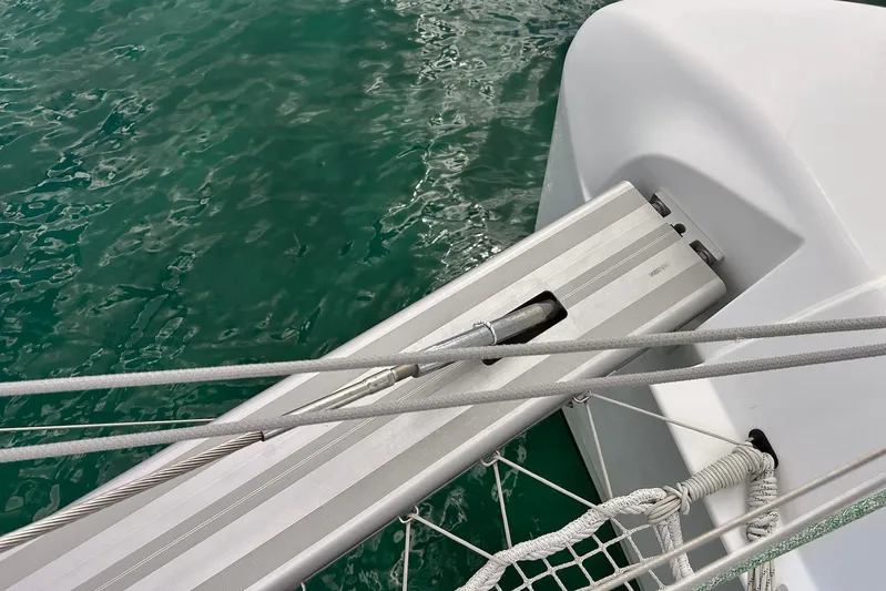  Yacht Photos Pics Close-up of Lagoon 42 catamaran deck detail, 2016 model, with green water background.