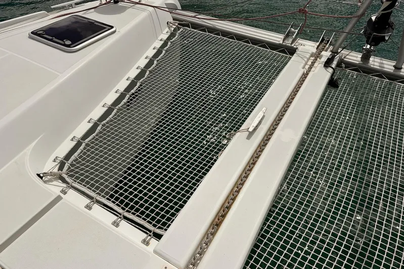  Yacht Photos Pics Trampoline netting on a 2016 Lagoon 42 catamaran, over clear water.