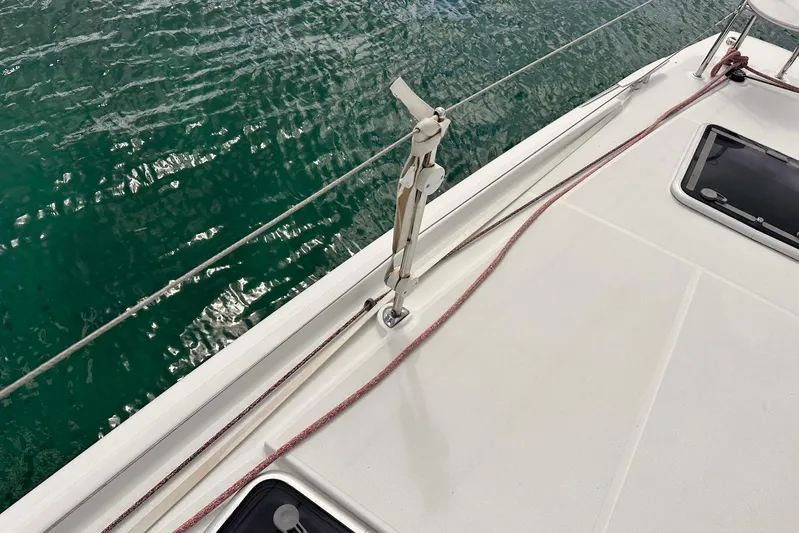  Yacht Photos Pics Deck of 2016 Lagoon 42 catamaran with railing and hatch, overlooking green water.