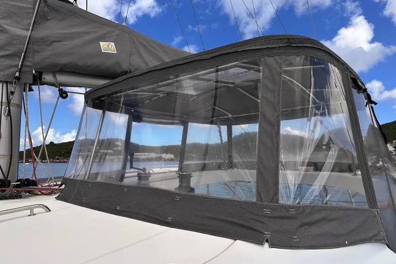  Yacht Photos Pics 2016 Lagoon 42 sailboat with clear cockpit enclosure under blue sky.