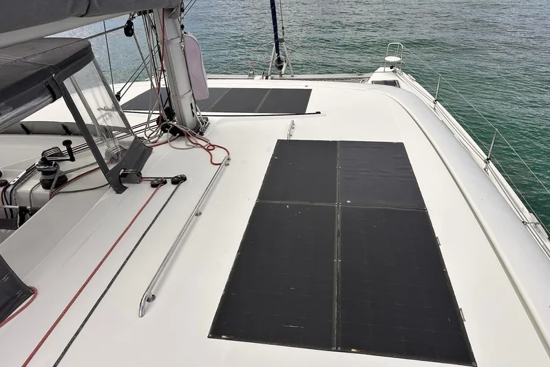  Yacht Photos Pics 2016 Lagoon 42 catamaran deck with solar panels and rigging, sailing on calm waters.