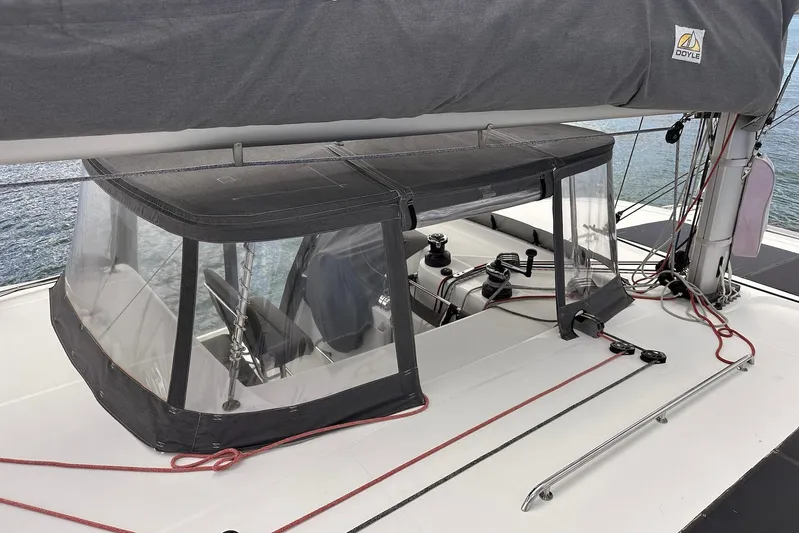  Yacht Photos Pics 2016 Lagoon 42 sailboat cockpit with protective canopy and winches, docked on calm water.