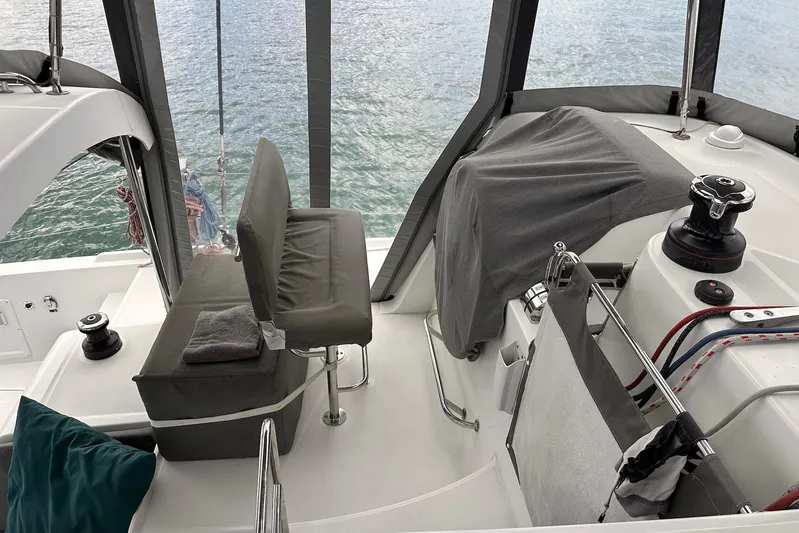  Yacht Photos Pics Cockpit of 2016 Lagoon 42 catamaran with seating and winch, overlooking water.