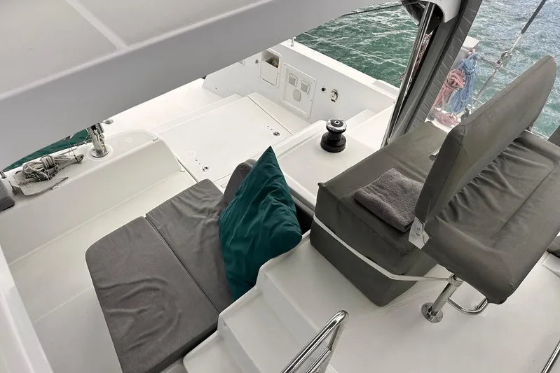  Yacht Photos Pics Interior view of a 2016 Lagoon 42 catamaran with cushioned seating and ocean backdrop.