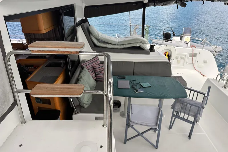  Yacht Photos Pics Cozy deck of 2016 Lagoon 42 catamaran with seating, table, and ocean view.