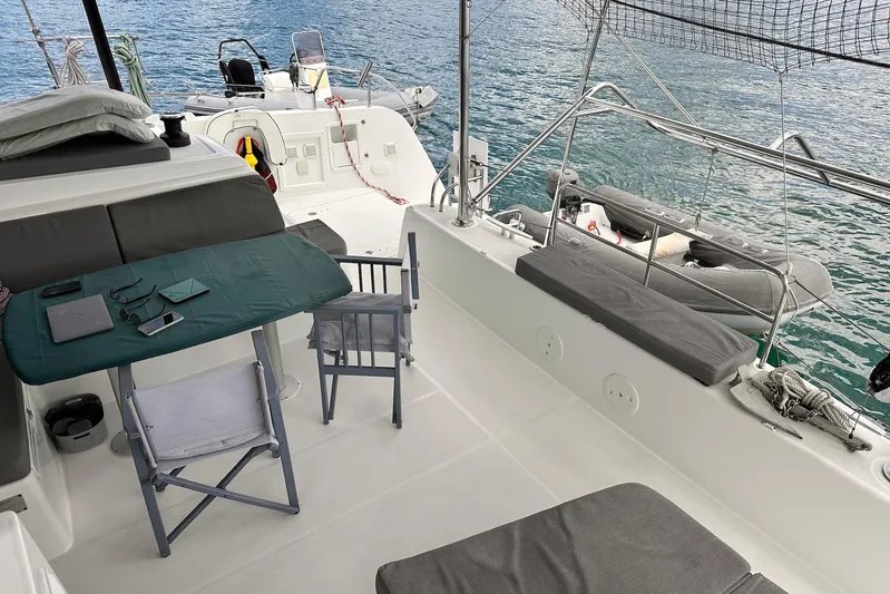  Yacht Photos Pics 2016 Lagoon 42 catamaran deck with seating, table, and ocean view.