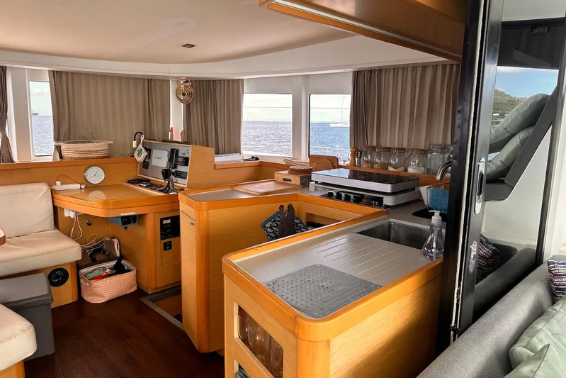  Yacht Photos Pics Interior of 2016 Lagoon 42 catamaran with modern kitchen and ocean view.